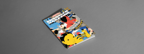 A comic book on a grey surface.