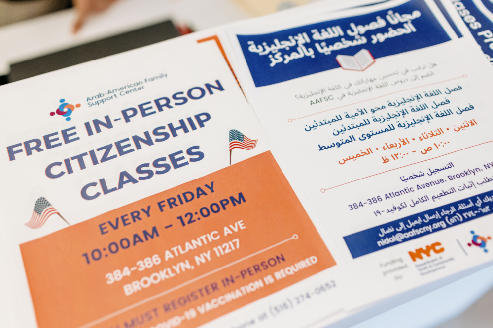 A closeup shot of flyers that advertise free in person citizenship classes provided by the Arab-American Family Support Center