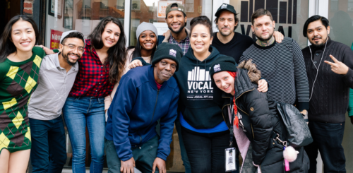 A group of people posing for a photo in front of a building.
