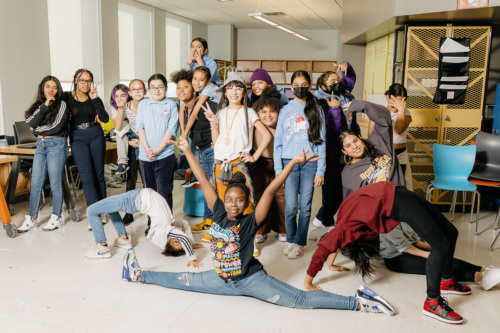 A group of young people posing for a photo in an office.