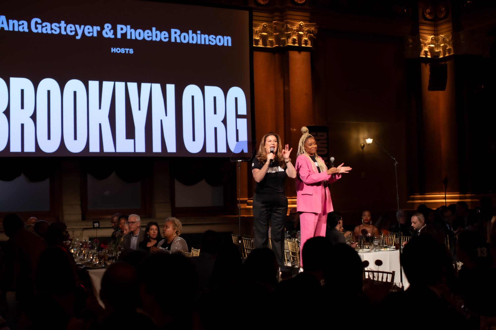 Two women on stage at an event for the brooklyn org.
