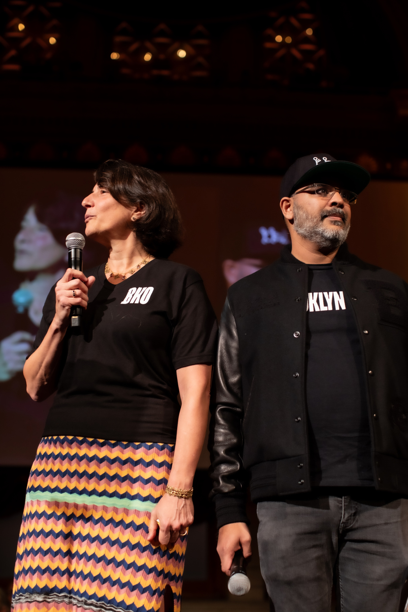 A man and a woman standing on stage.
