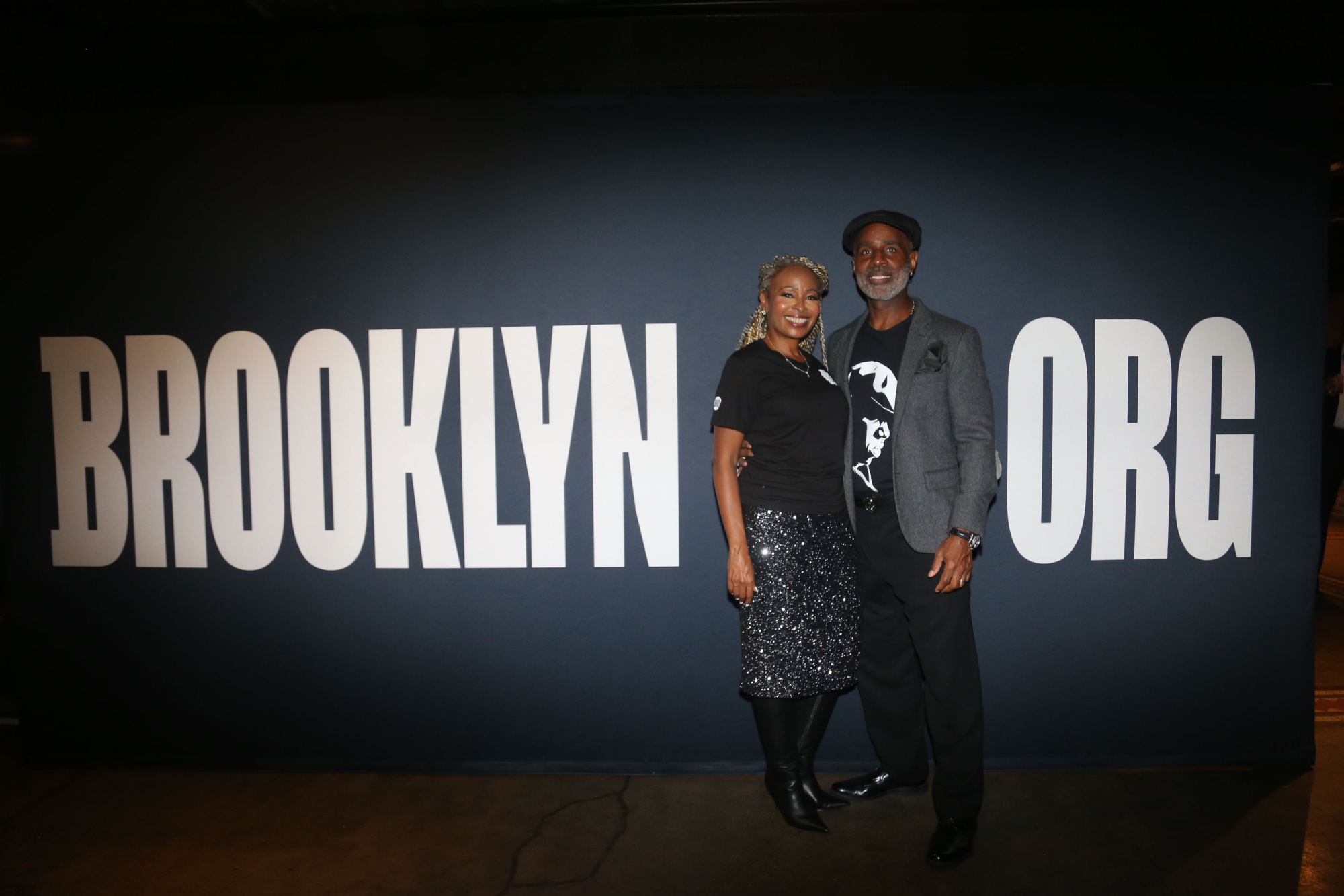 Two people standing in front of the brooklyn org sign.