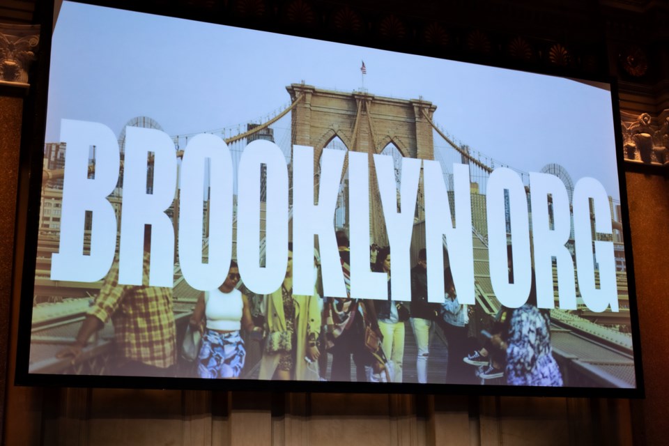 The Brooklyn Org logo is shown on a screen in front of a group of people.