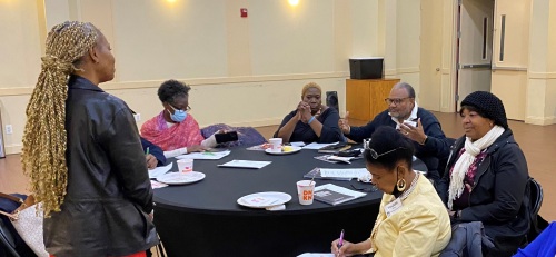 A group of people sitting around a table.