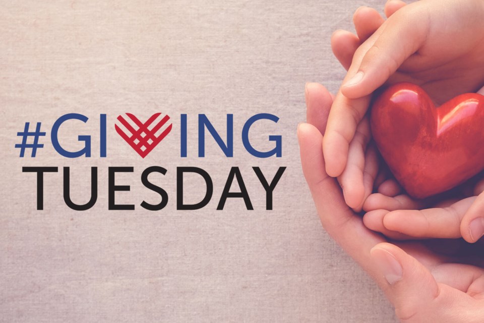 Giving tuesday logo with two hands holding a red heart.