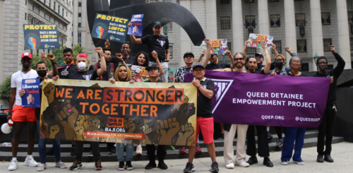 A group of people holding banners in front of a building.