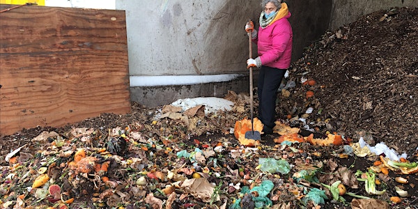 A woman is standing next to a pile of garbage.