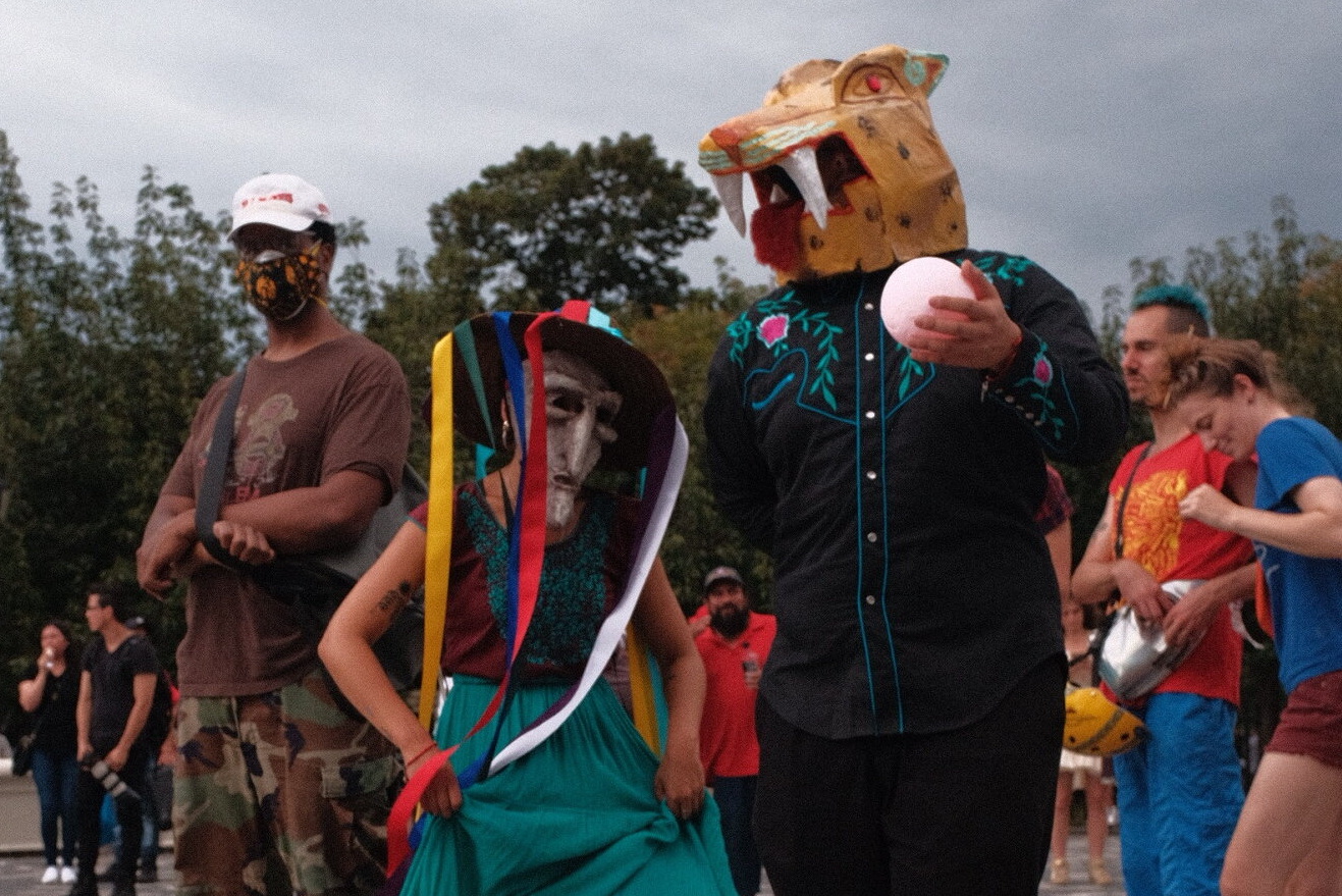 People wearing tiger masks and costumes at a summer festival.
