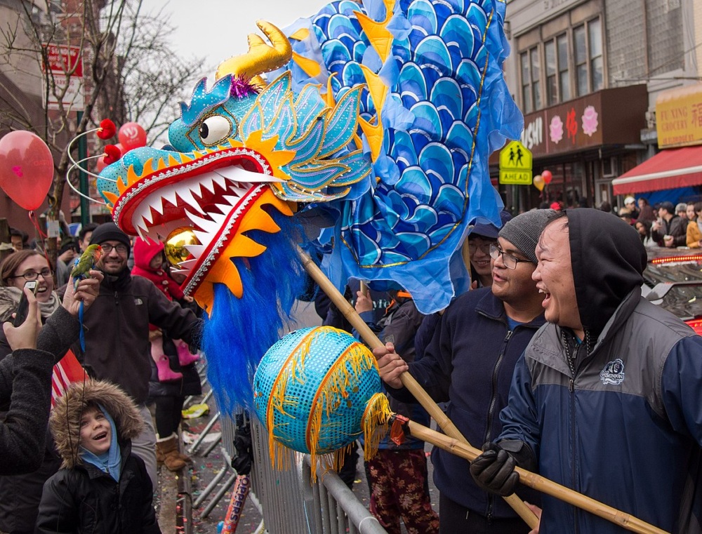 Parade members hold a large blue Chinese Dragon puppet up for the crowd at the Lunar New Year parade in New York City.