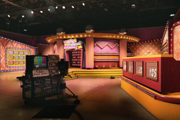 A set of a game show with tvs and a stage.