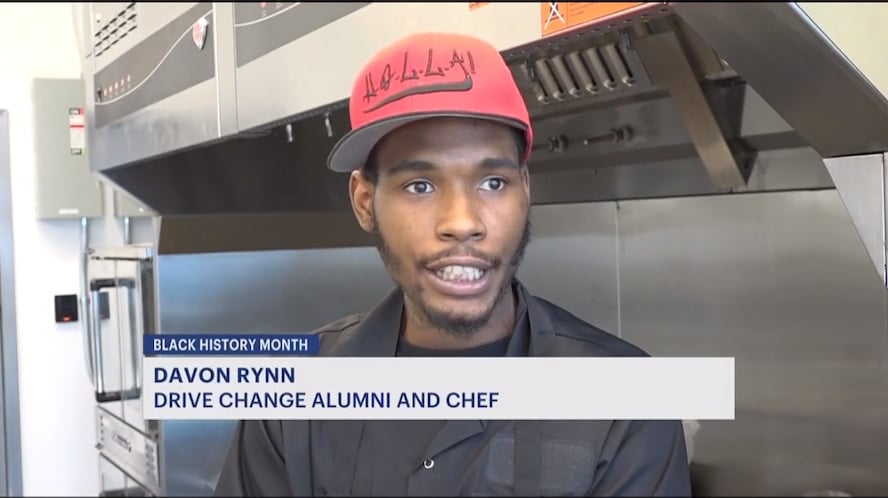 A young chef named davon rynn, associated with drive change, speaks during an interview in a kitchen setting in honor of black history month.