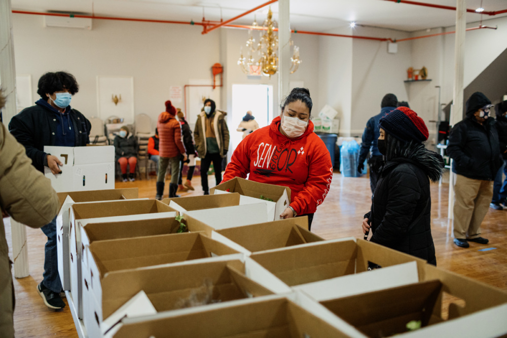 Volunteers distributing supplies in a community center.