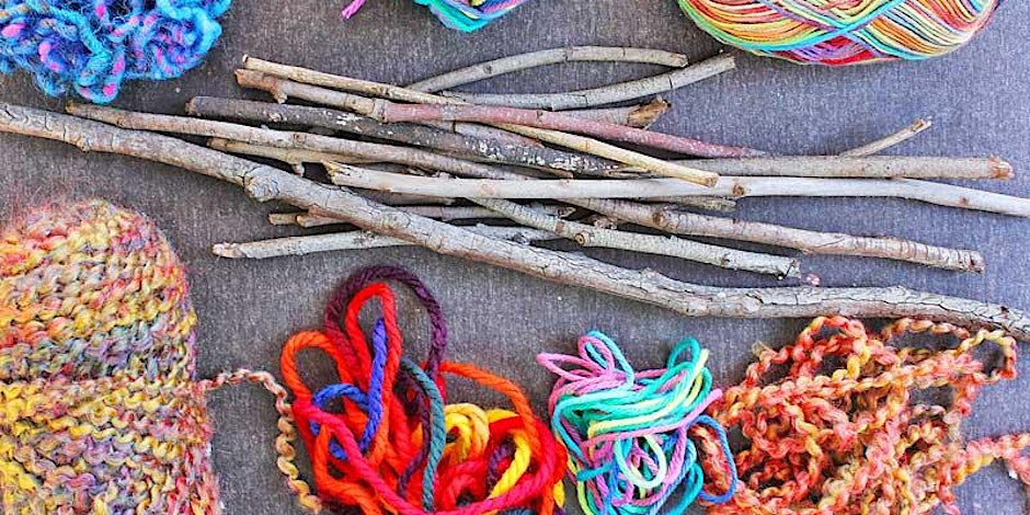 Bundles of colorful yarn and sticks on the ground.