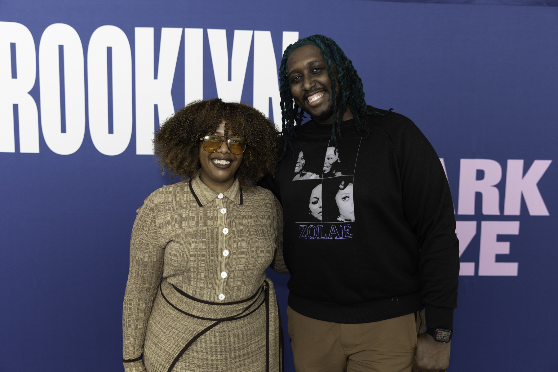 Two individuals smiling for a photo at a "brooklyn talks" event.