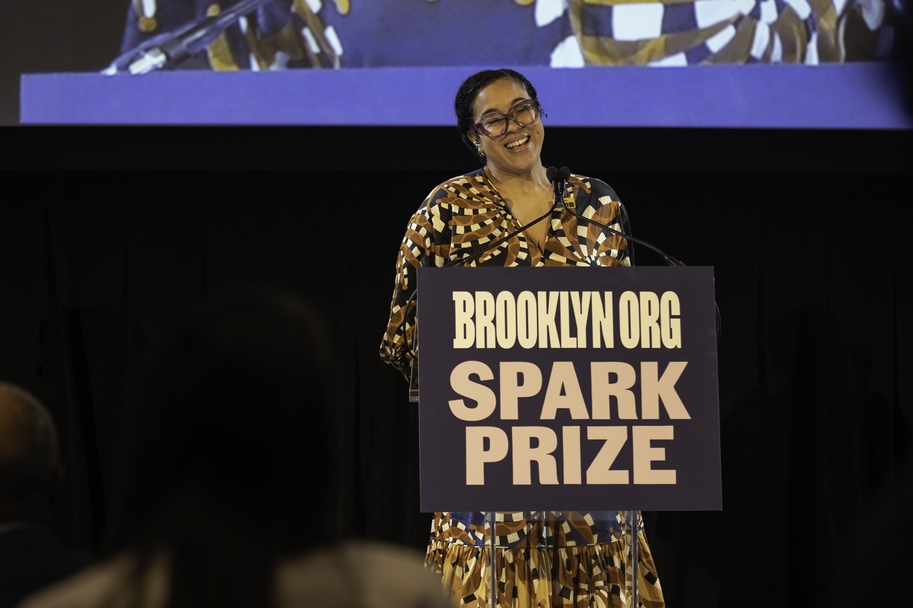 Woman speaking at the brooklyn.org spark prize event.