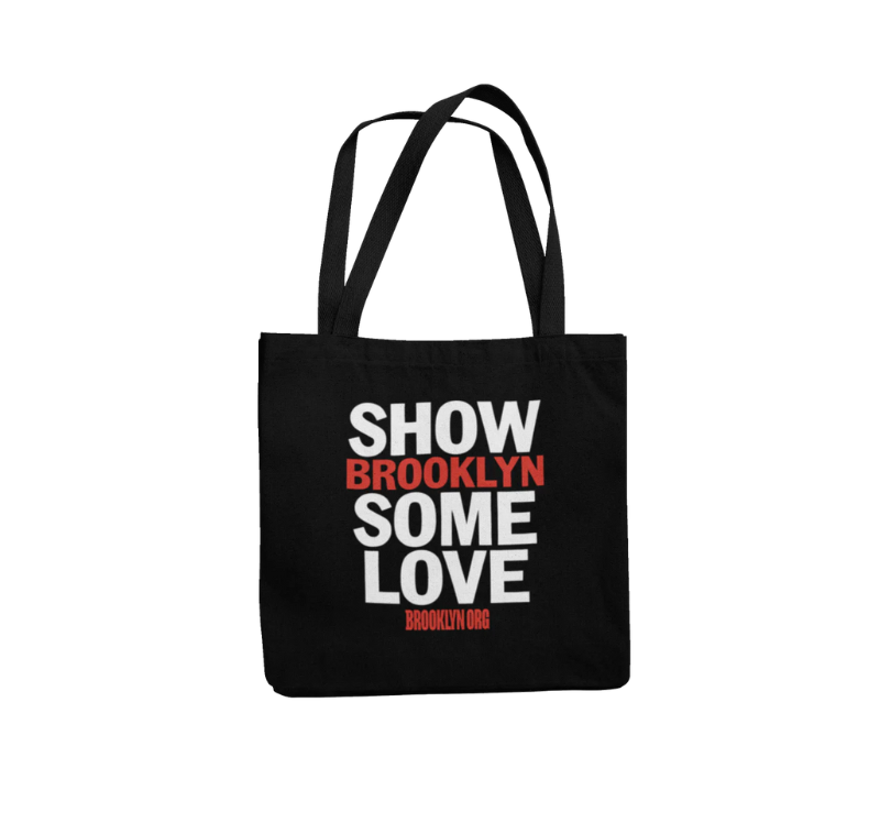 Black tote bag with the words "SHOW BROOKLYN SOME LOVE" printed in large white and red fonts. Below, a smaller "BROOKLYN.ORG" is printed in red.