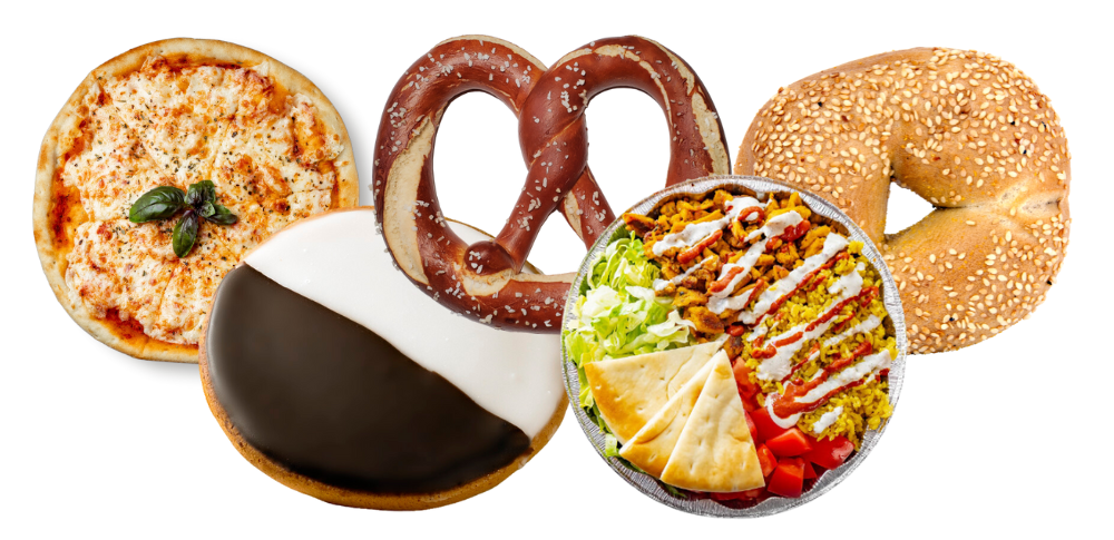 A variety of foods including a pizza, soft pretzel, sesame bagel, black-and-white cookie, and a bowl of salad with pita.