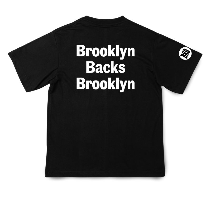 Back of a black t shirt with "Brooklyn Backs Brooklyn" in large white text on it.