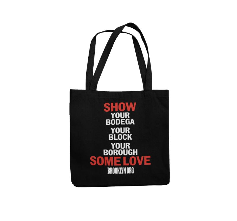 Black tote bag with text: "SHOW YOUR BODEGA YOUR BLOCK YOUR BOROUGH SOME LOVE" in white and red, followed by "BROOKLYN ORG" in white.