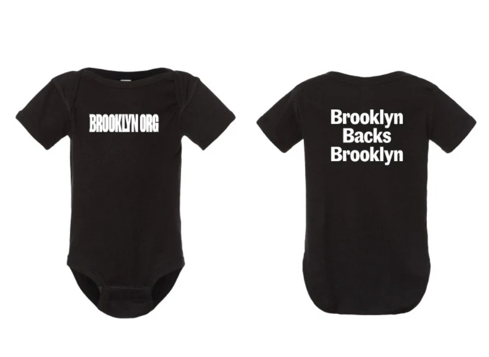 Two black onesies with white text. Front: "BROOKLYN.ORG." Back: "Brooklyn Backs Brooklyn.