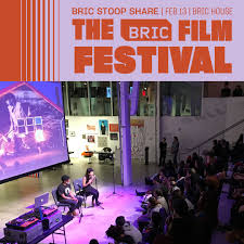 BRIC Film Festival event with two speakers on stage, audience seated, and projection screen in a modern venue.