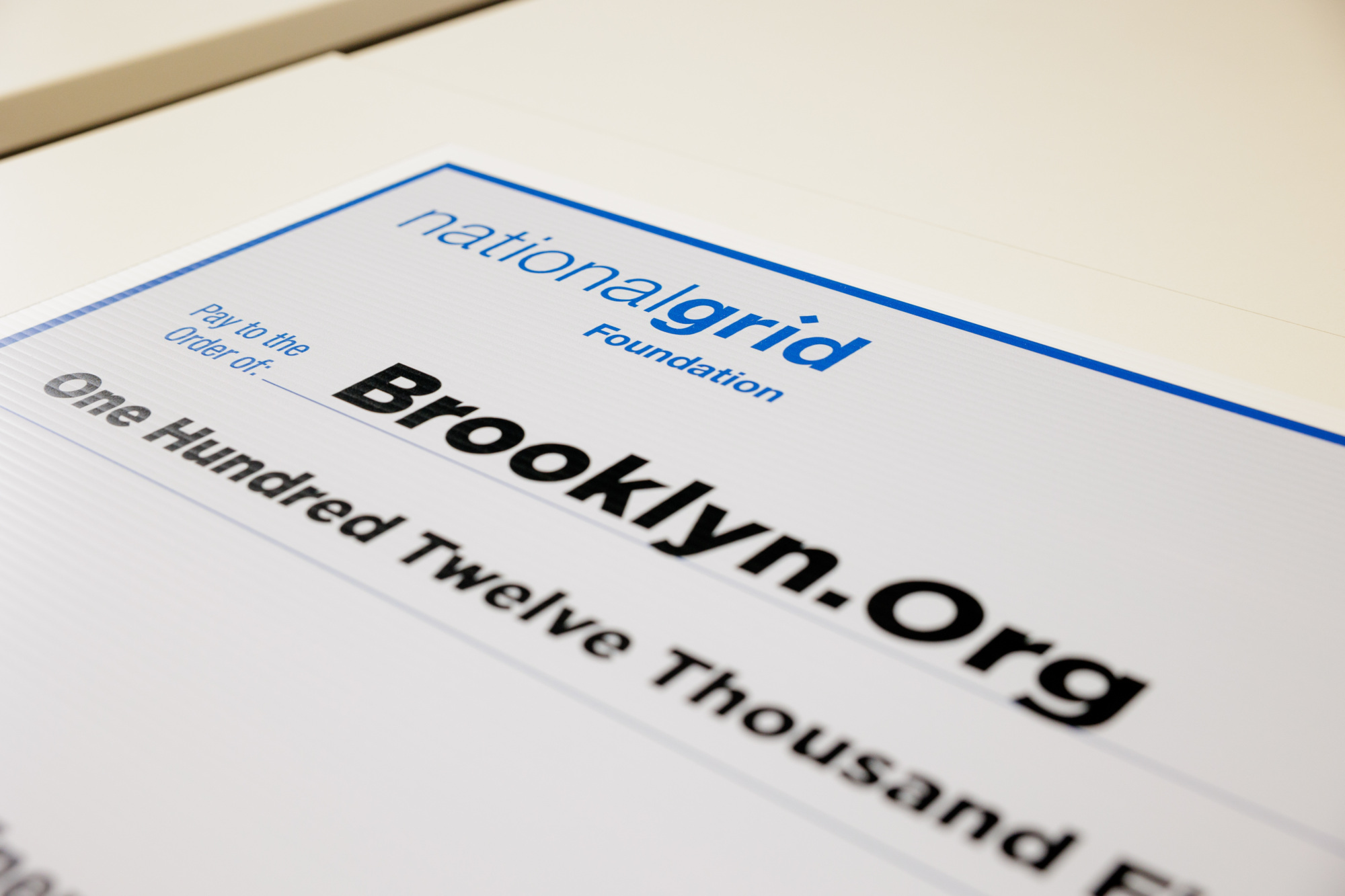 Close-up of a ceremonial check from National Grid Foundation to Brooklyn.Org for One Hundred Twelve Thousand Five Hundred Dollars.