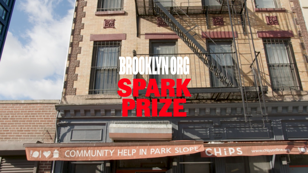 Brick building with fire escape, displaying "BROOKLYN.ORG SPARK PRIZE" in red text. Banner reads "COMMUNITY HELP IN PARK SLOPE" with "CHiPS" logo.