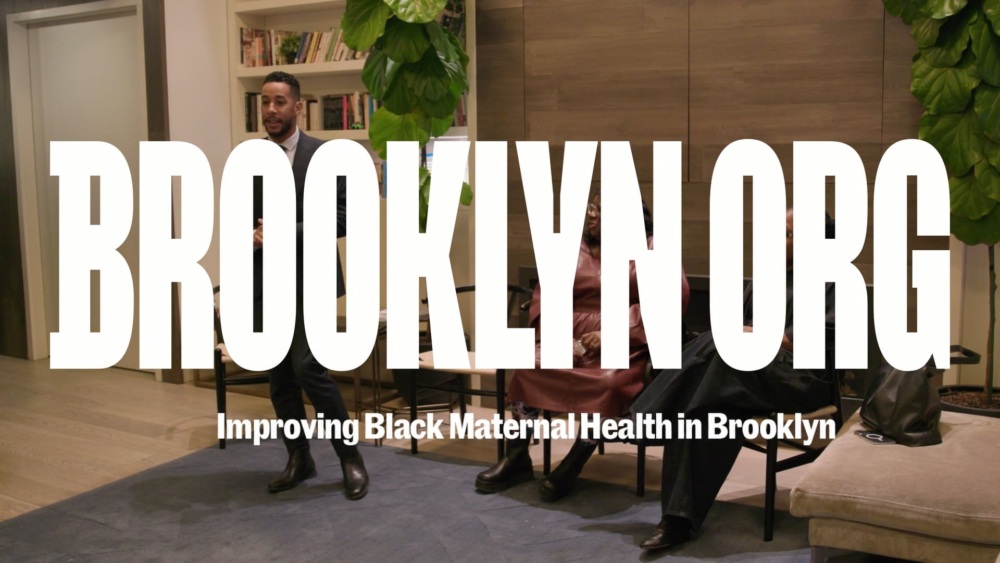 People sitting in a room with large text "BROOKLYN ORG" and "Improving Black Maternal Health in Brooklyn" displayed over the image.