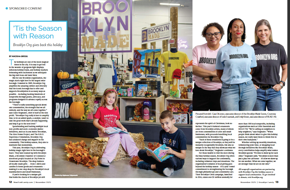 Three children read books amid autumn decor inside a Brooklyn Made shop; three adults wearing Brooklyn Org shirts stand to the right, smiling in front of a display of merchandise.