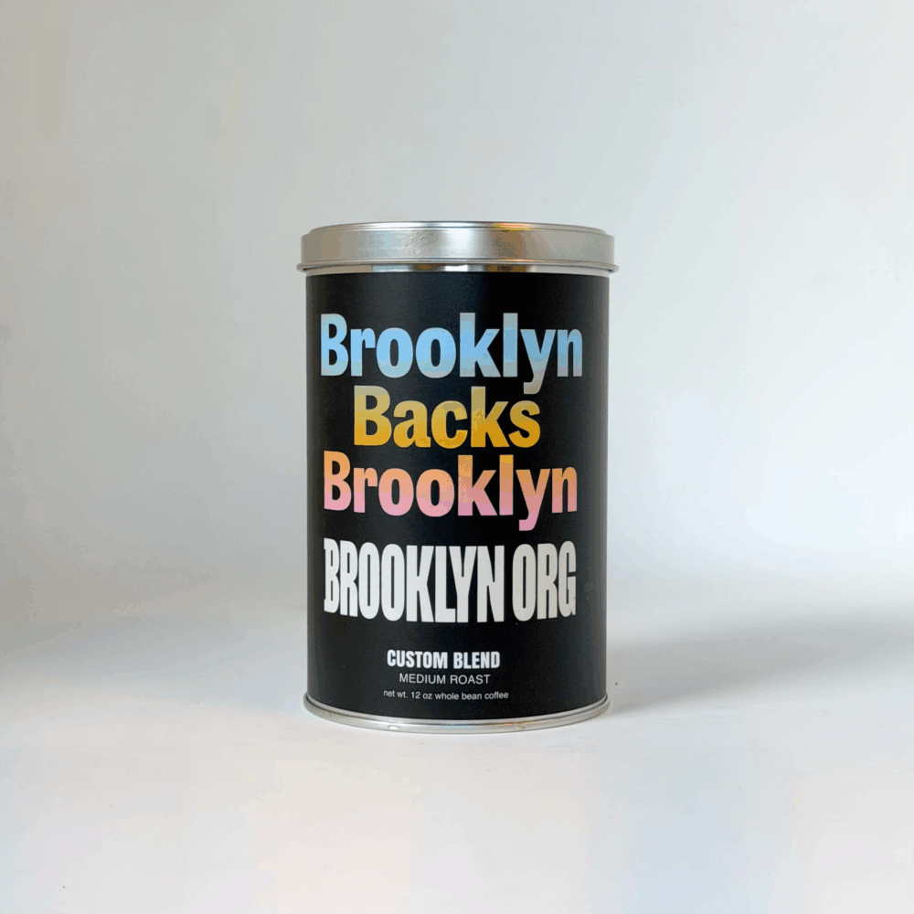 A black coffee can labeled "Brooklyn Backs Brooklyn" in colorful text, with "Custom Blend Medium Roast" written below.