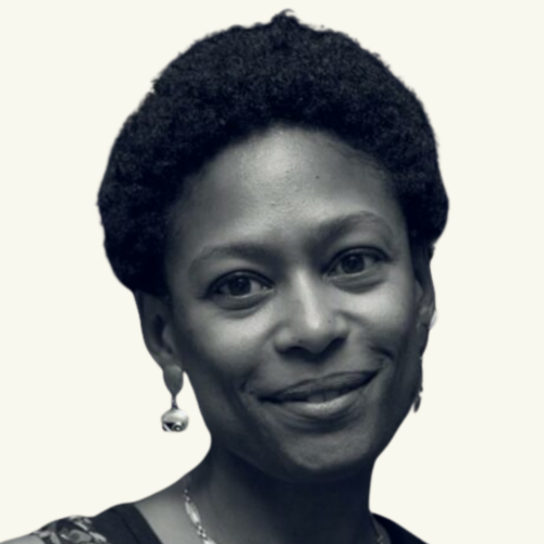 Black and white portrait of a woman with short curly hair, wearing earrings and smiling softly, shown from the shoulders up against a light background.