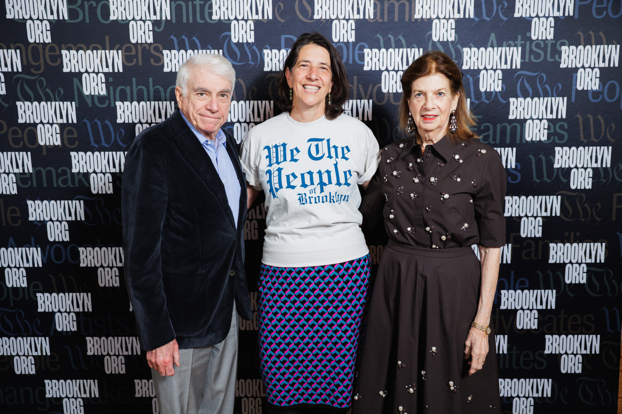 Three people posing in front of a step-and-repeat backdrop with the text “Brooklyn.org.”